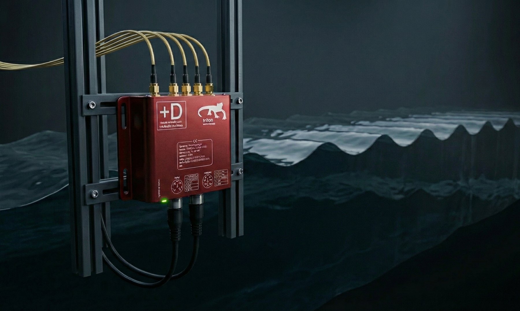 Triton 2 mounted on a metal arc structure in front of waves